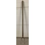 A vintage wooden handled pitchfork.