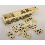 A carved bone miniature domino set with sliding drawer compartment.