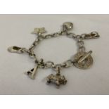 A silver charm bracelet with T bar fixing, by Links of London, complete with 6 charms.