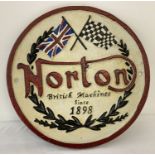 A circular painted cast iron "Norton" wall hanging plaque.