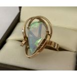 A 9ct gold bespoke contemporary design dress ring set with large teardrop shaped opal.