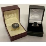 2 dress rings. A 925 silver ring with multi faceted black stone & pierced work detail to mount.
