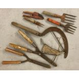 8 vintage hand garden tools. To include shears, hand forks and hand scythe.
