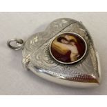 A silver heart shaped vesta case with central ceramic panel depicting a nude.