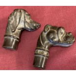 2 bronze walking cane handles in the shape of dogs heads.
