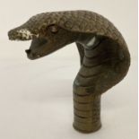 A vintage brass snakes head walking stick handle.
