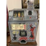 A "One Arm Bandit" 3 wheel slot machine in witch and cat design, marked with Jennings logo.