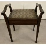 A vintage mahogany piano stool with spade feet and upholstered and stud detail seat.