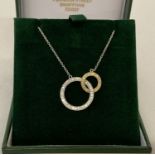 An 18ct white and yellow gold entwined circles diamond necklace by Luke Stockley, London.