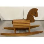 A children's modern design pine wooden rocking horse with slatted dome style body/seat.