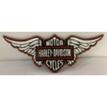 A modern cast iron Harley Davidson wall hanging plaque in the shape of wings.