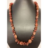 A vintage carnelian beaded 22" necklace with screw clasp.