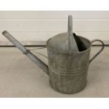 A vintage galvanised watering can.