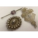 3 vintage white metal brooches. An Art Nouveau bar brooch set with amethyst and marcasite's.