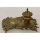 A vintage classical design copper and brass ink stand with ceramic liner to ink well.