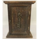 A small wooden key cabinet with metal key detail to front. Interior has 8 hanging hooks.