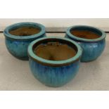 A set of 3 green/blue glazed garden plant pots.