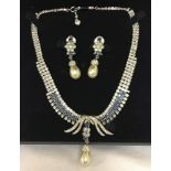 A boxed vintage style matching necklace and earrings set of classical design.