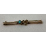 A vintage 9ct gold small bar brooch set with a small turquoise stone and 3 seed pearls.