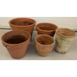 A collection of 5 terracotta garden plant pots in various sizes.