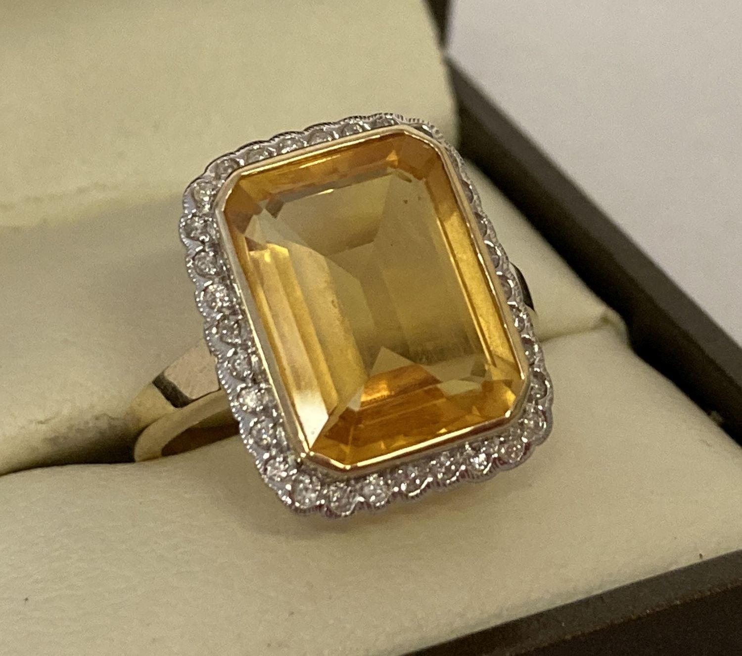 A 9ct gold citrine and diamond dress ring by Luke Stockley, London.