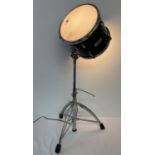 An unusual lamp made from a drum on an adjustable chrome tripod stand.