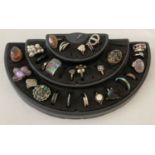 A collection of 28 vintage and modern costume jewellery rings with a ring display stand.