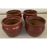 3 matching ceramic garden planters with burgundy and black speckle glaze.