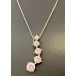 A modern design silver pendant set with graduating size round cut cubic zirconia's.