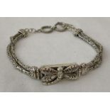 A decorative double strand silver bracelet with central panel decorated with dragonfly detail.