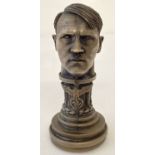 A modern cast metal seal in the form of Hitler's head with eagle and swastika insignia.