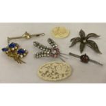 A collection of 7 vintage brooches to include stone set, early plastic and marcasite set.