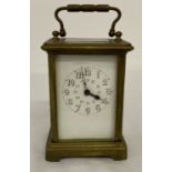A vintage heavy brass carriage clock with enamel face. Glass panels to top, back and sides.