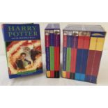 A collection of "Harry Potter" boxed sets and first edition hardback books by J.K. Rowling.