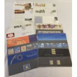 A collection of Royal Mail collectors stamp sets, with information cards.