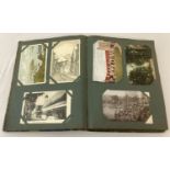 A vintage album containing a collection of 148 antique and vintage greetings cards and postcards.