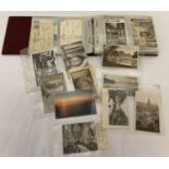 A red album of approx 75 vintage postcards to include hand tinted.