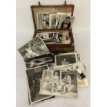 A small brown suitcase containing a quantity of assorted vintage photographs.