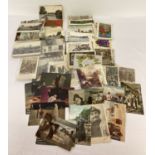 A collection of 100+ antique and vintage postcards and greetings cards.