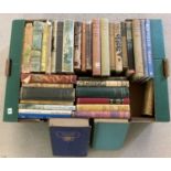 A box of vintage fiction books and novels, many complete with dust covers.