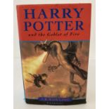 A hardback copy of "Harry Potter and the Goblet of Fire" by J.K. Rowling, printed by Omnia Books.
