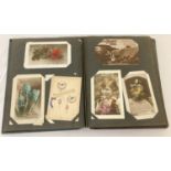 An Art Nouveau album containing approx. 140 antique and vintage postcards & Edwardian photographs.