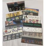 A collection of 8 Royal Mail collectors stamp sets, with information cards.