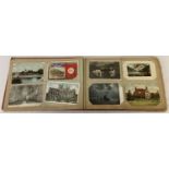 A vintage red postcard album containing approx. 100 assorted vintage postcards.