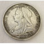 An 1897 Victoria veiled head silver crown coin.