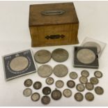 A collection of antique and vintage coins together with a small wooden money box.
