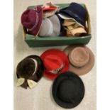 A box of assorted vintage felt and wool ladies hats and berets.