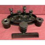 A collection of vintage ebony items, to include candlesticks, tray, comb and lidded pots.
