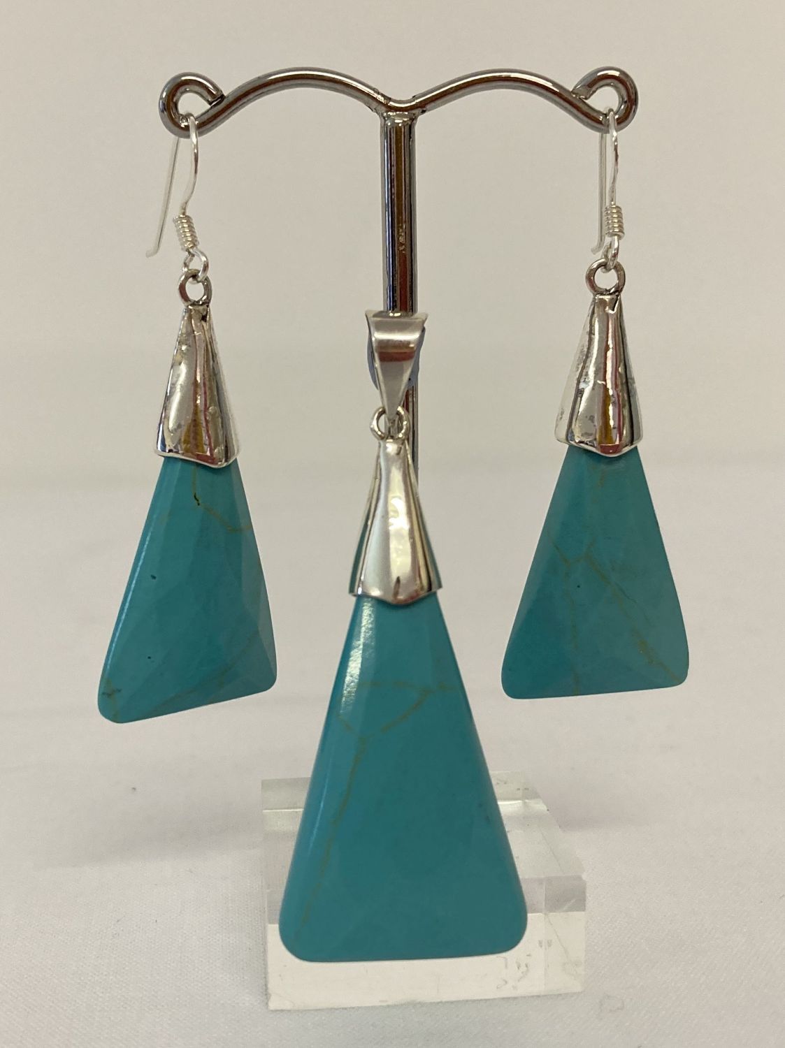 A triangular shaped turquoise style pendant, with 925 silver mount & bale.