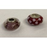 2 Pandora glass charm beads. A pink bubble charm and a red charm with pink hearts.